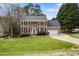 Charming two-story brick home with manicured lawn and attached two-car garage at 1716 Turtle Ridge Way, Raleigh, NC 27614