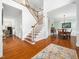 Bright foyer featuring hardwood floors, staircase and views to dining room at 1716 Turtle Ridge Way, Raleigh, NC 27614