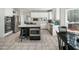 Well-equipped kitchen with stainless steel appliances, white cabinets, cooktop, island and tile flooring at 1716 Turtle Ridge Way, Raleigh, NC 27614