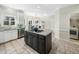 Bright eat-in kitchen featuring a center island with cooktop, stainless steel appliances, and tile flooring at 1716 Turtle Ridge Way, Raleigh, NC 27614