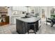 Modern kitchen with granite countertops, white cabinets, gas cooktop and an island with seating at 1716 Turtle Ridge Way, Raleigh, NC 27614