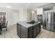 Spacious kitchen with a gray island and stainless steel appliances, perfect for cooking and entertaining at 1716 Turtle Ridge Way, Raleigh, NC 27614