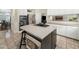 Modern kitchen featuring stainless steel appliances, island with cooktop and microwave, and tiled floors at 1716 Turtle Ridge Way, Raleigh, NC 27614