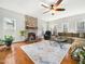 Bright and airy living room with fireplace, ceiling fan, hardwood floors and a comfortable sofa at 1716 Turtle Ridge Way, Raleigh, NC 27614