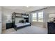 Bright bedroom features a bunk bed, a large window, and neutral decor at 201 Hiddenite Pl, Holly Springs, NC 27540