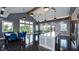 Bright clubhouse interior with large windows, tables with blue chairs and a kitchen island for hosting community events at 201 Hiddenite Pl, Holly Springs, NC 27540