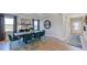 Elegant dining room featuring a large table, stylish chairs, and ample natural light at 201 Hiddenite Pl, Holly Springs, NC 27540