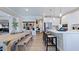 Bright, open-concept kitchen featuring modern appliances, a large island, and a dining area at 201 Hiddenite Pl, Holly Springs, NC 27540