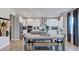Bright, open-concept kitchen featuring modern appliances, a large island, and a dining area at 201 Hiddenite Pl, Holly Springs, NC 27540