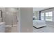 Bright bedroom with bathroom featuring a glass-enclosed shower at 201 Hiddenite Pl, Holly Springs, NC 27540
