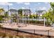 Community playground with a fence, climbing structures, and seating, perfect for outdoor recreation and Gathering fun at 201 Hiddenite Pl, Holly Springs, NC 27540