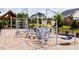 Fun playground with climbing structures and soft ground cover, designed for enjoyment in the community at 201 Hiddenite Pl, Holly Springs, NC 27540