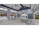 Elegant pool clubhouse interior with ample seating, a serving area, and direct access to the pool for community gatherings at 201 Hiddenite Pl, Holly Springs, NC 27540