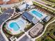 Aerial view of a community pool area with a playground and abundant parking, creating a Gathering-friendly atmosphere at 201 Hiddenite Pl, Holly Springs, NC 27540