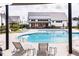 Beautiful pool area with comfortable lounge chairs and a serene setting, perfect for leisure and socializing at 201 Hiddenite Pl, Holly Springs, NC 27540