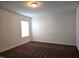 This bedroom features carpeted floors, neutral walls, and a window with natural light at 2015 Tennessee Road Rd, Durham, NC 27704