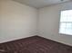 This bedroom features neutral walls, and a window providing natural light at 2015 Tennessee Road Rd, Durham, NC 27704