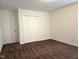 This bedroom features carpeted floors, neutral walls, and a double-door closet at 2015 Tennessee Road Rd, Durham, NC 27704