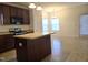 Kitchen featuring an island, dark cabinets and stainless steel microwave and oven at 2015 Tennessee Road Rd, Durham, NC 27704