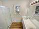 Well-lit bathroom with double vanity, new hardwood floor and shower at 204 Lopez Ln, Clayton, NC 27527