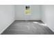 Bright bedroom with plush carpeting, a large window with natural light, and neutral paint at 204 Lopez Ln, Clayton, NC 27527
