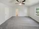 Spacious bedroom featuring a vaulted ceiling, neutral walls, plush carpeting, and a ceiling fan at 204 Lopez Ln, Clayton, NC 27527