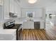 Modern kitchen with stainless steel appliances, white cabinets, and hardwood floors at 204 Lopez Ln, Clayton, NC 27527