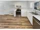Stylish kitchen with stainless steel appliances, white cabinets, and hardwood floors at 204 Lopez Ln, Clayton, NC 27527