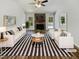 Bright living room with stone fireplace, plush seating, and modern decor at 204 Lopez Ln, Clayton, NC 27527