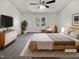 Serene main bedroom featuring a cozy bed, modern decor, and ample natural light at 204 Lopez Ln, Clayton, NC 27527