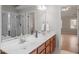 Well-lit double sink vanity in bathroom with neutral tones and large mirror, creating a serene space at 205 Caniff Ln, Cary, NC 27519