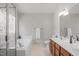 Bathroom featuring a soaking tub, sleek fixtures, and double sink vanity, designed for relaxation and convenience at 205 Caniff Ln, Cary, NC 27519