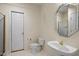 Bathroom featuring a white vanity with a unique faucet and a framed mirror, complemented by neutral walls at 205 Caniff Ln, Cary, NC 27519