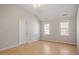 Bright bedroom with beautiful windows allowing natural light and complementing the hardwood floors at 205 Caniff Ln, Cary, NC 27519
