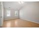 Spacious bedroom features natural light and warm-toned hardwood floors, creating a welcoming atmosphere at 205 Caniff Ln, Cary, NC 27519