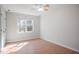 Comfortable bedroom with hardwood floors, a ceiling fan, and a bright window creating a warm ambiance at 205 Caniff Ln, Cary, NC 27519
