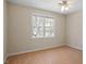 Bright bedroom featuring hardwood floors, neutral walls, and natural light from a double window at 205 Caniff Ln, Cary, NC 27519
