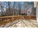 Large wooden deck with railing overlooking the yard with trees at 205 Caniff Ln, Cary, NC 27519