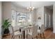 Elegant dining room featuring hardwood floors, a chandelier, and a large bay window at 205 Caniff Ln, Cary, NC 27519