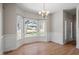 Elegant dining room featuring hardwood floors, a chandelier, and a large bay window at 205 Caniff Ln, Cary, NC 27519