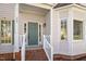 Inviting front porch with brick steps, white railings, and a blue front door at 205 Caniff Ln, Cary, NC 27519
