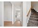 Bright hallway featuring hardwood floors, stairs and a view of a living room with a fireplace at 205 Caniff Ln, Cary, NC 27519