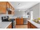 Well-lit kitchen features stainless steel appliances and ample counter space overlooking a large, open living room at 205 Caniff Ln, Cary, NC 27519