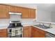 Kitchen with stainless steel appliances, wood cabinets and laminate countertop at 205 Caniff Ln, Cary, NC 27519