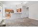 Carpeted living room with a view into the kitchen and an exterior entrance at 205 Caniff Ln, Cary, NC 27519