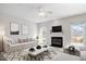 Staged living room featuring fireplace, neutral decor, and bright, natural light at 205 Caniff Ln, Cary, NC 27519