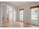 Light-filled living room with hardwood floors, large windows, and neutral paint at 205 Caniff Ln, Cary, NC 27519