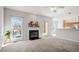 Carpeted living room with fireplace and windows with beautiful natural light at 205 Caniff Ln, Cary, NC 27519