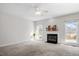 Bright living room featuring fireplace and large windows at 205 Caniff Ln, Cary, NC 27519
