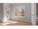 Well-lit room with natural light with door and window with view of a wooden deck at 205 Caniff Ln, Cary, NC 27519